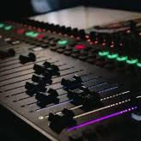 a dark picture of a digital mixing board
